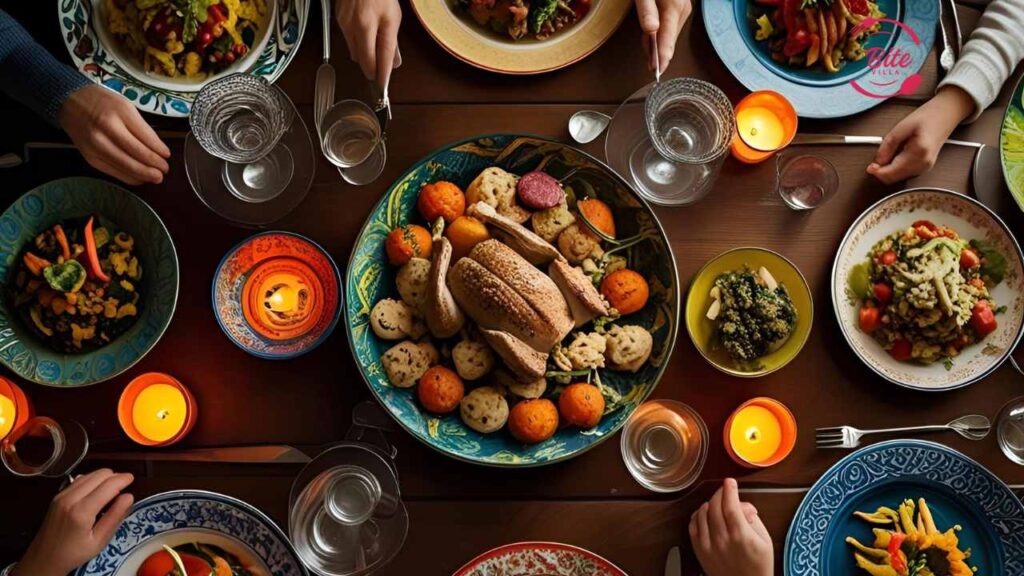 A warm, inviting dinner table with a roasted turkey centerpiece surrounded by colorful vegetables and bread. Five hands reach for food under candlelight.
